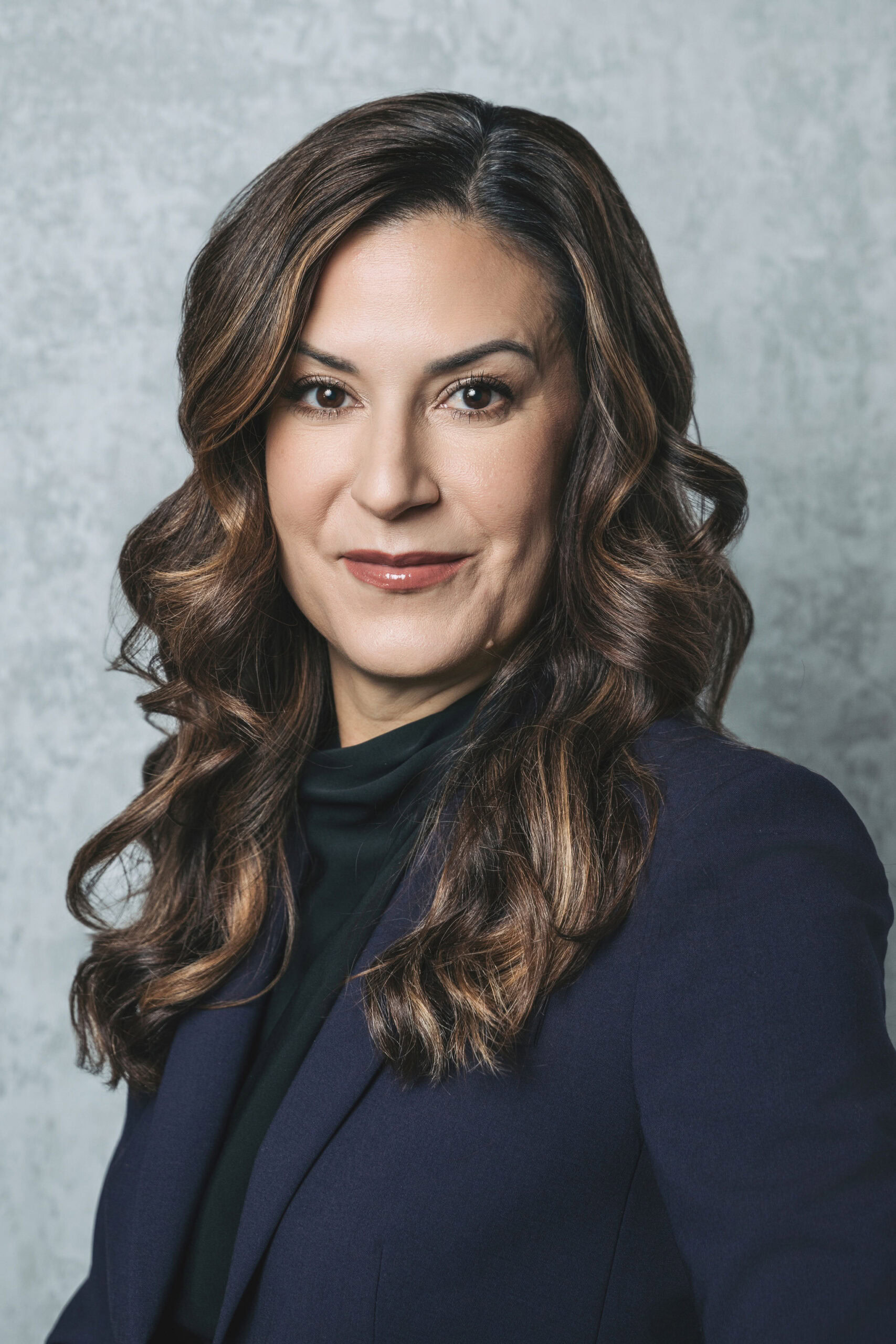 Professional headshot of woman in navy blazer