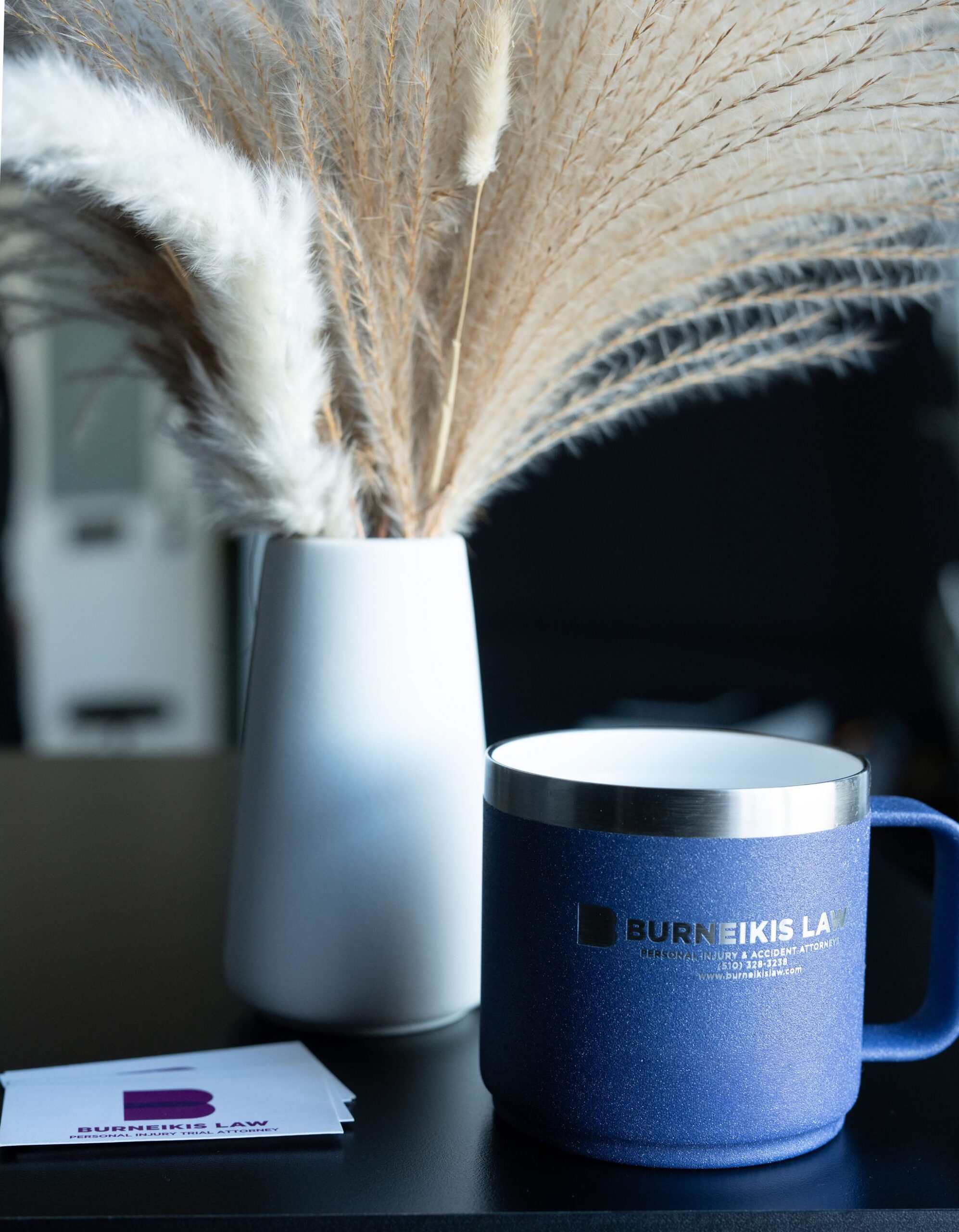 Blue branded mug and pampas grass vase